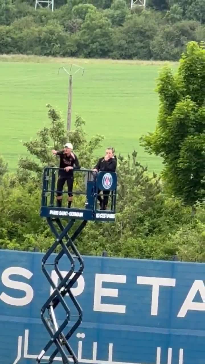 PSG coach Luis Enrique was overseeing a training session from an elevated scissor lift
