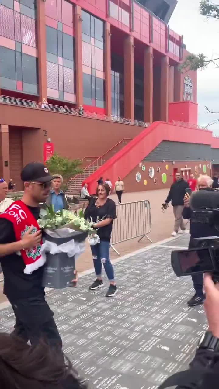 Jordan Henderson laying flowers outside Anfield for Diogo Jota