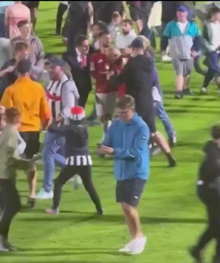 Bruno Fernandes rushed to protect Mbeumo when Grimsby fans invaded the pitch.
