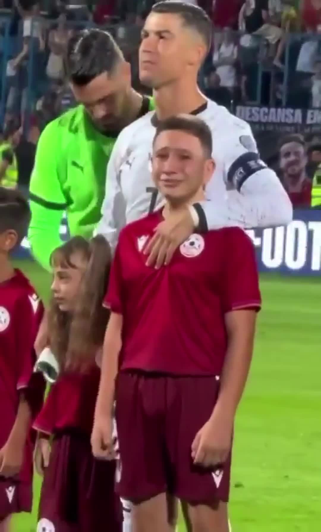 The boy’s reaction while standing with Ronaldo during the national anthem before the match against Armenia (2)