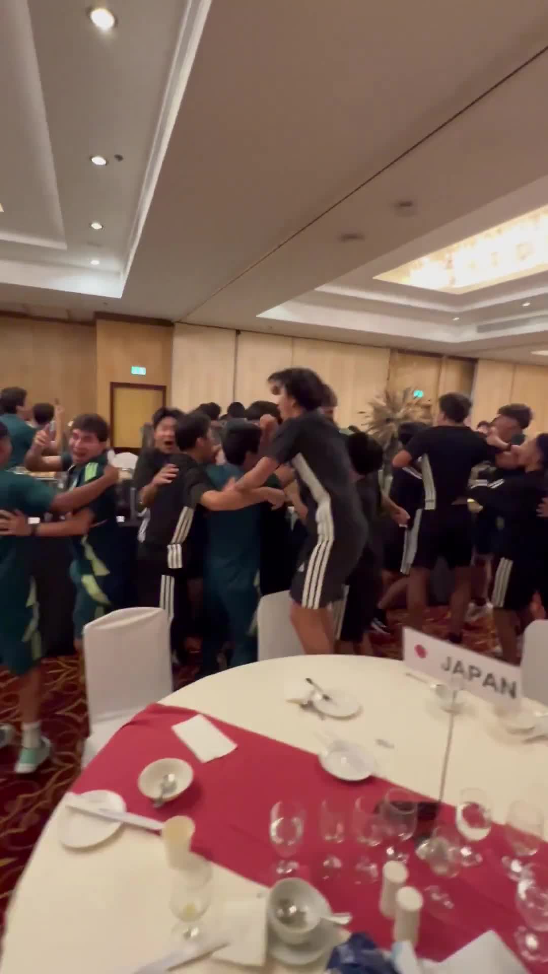 The Mexican and Japanese players celebrating together when Mexico officially advanced to the next round of the U-17 World Cup