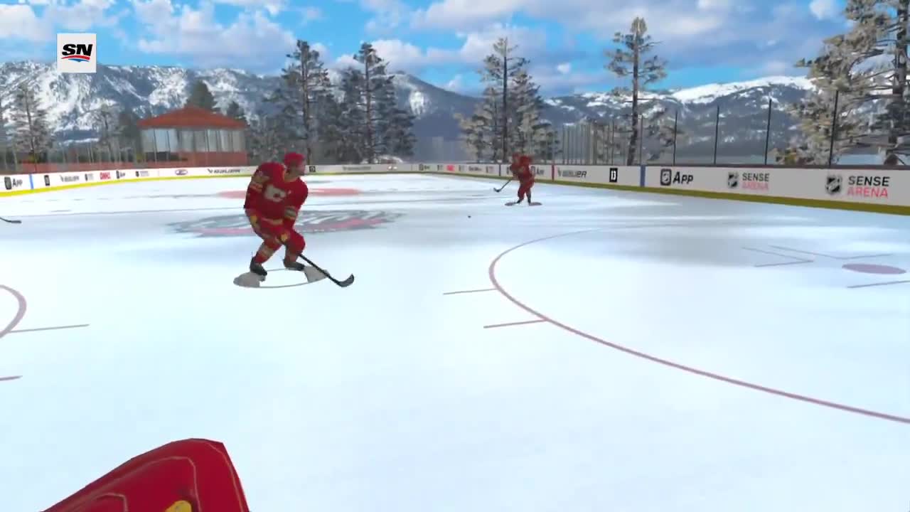 Flames tendy Devin Cooley uses a VR headset to take virtual warmup pucks before games