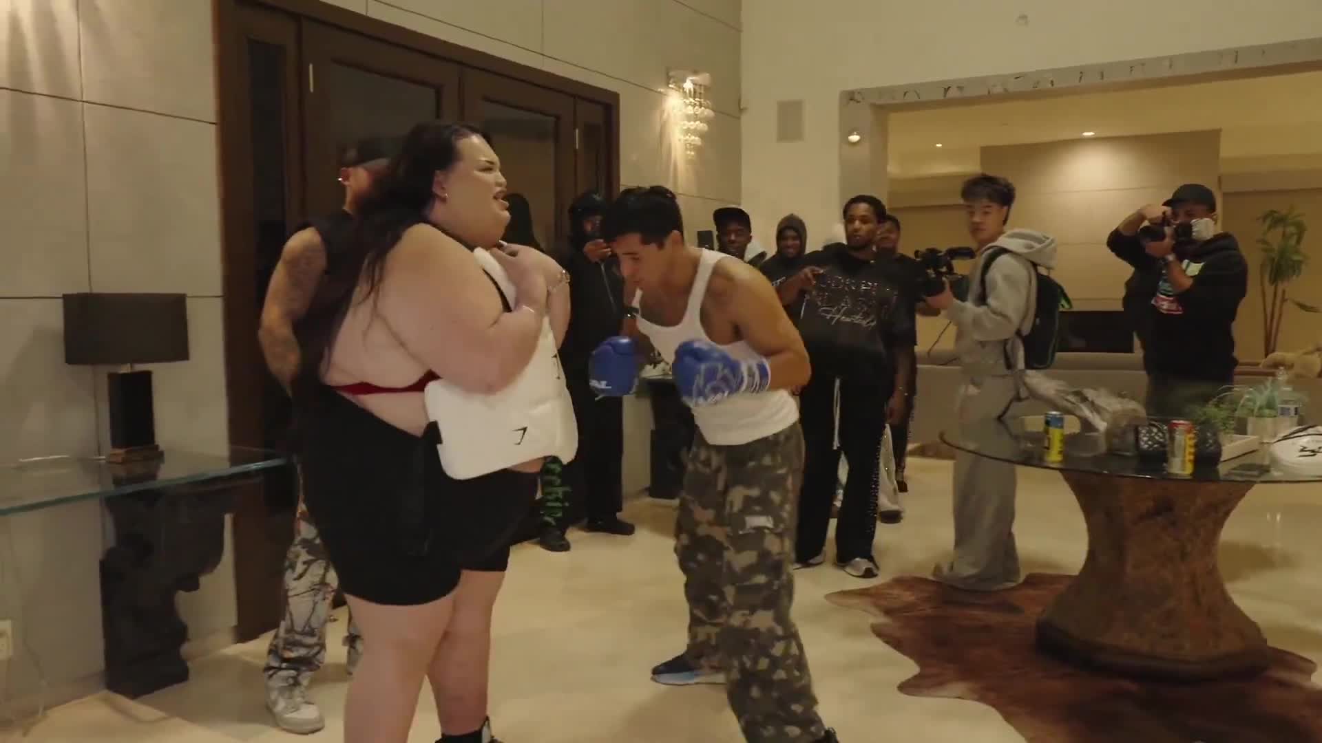 Ryan Garcia trains his punches with a female fan wearing a body protector.