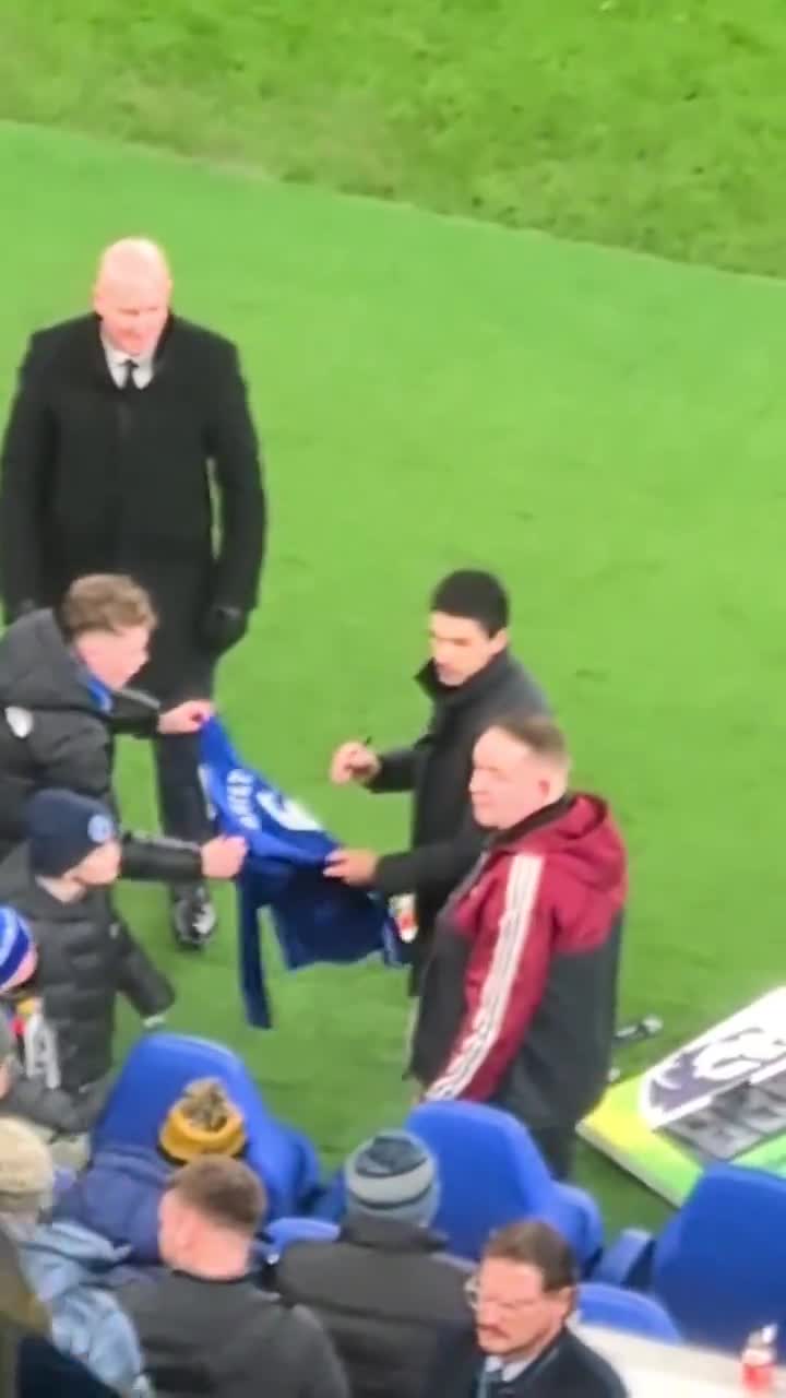 Mikel Arteta signs a shirt for an Everton fan, at the full-time whistle after Arsenal beat Everton
