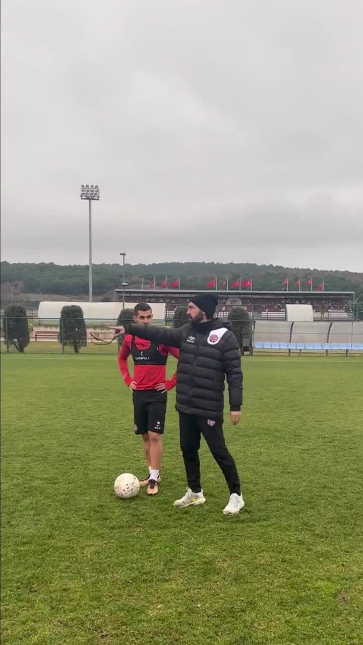 Andrea Pirlo guides Levent Mercan on free kicks during training”