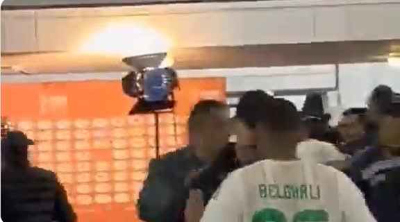 Algeria players confront the referee after losing 2-0 to Nigeria