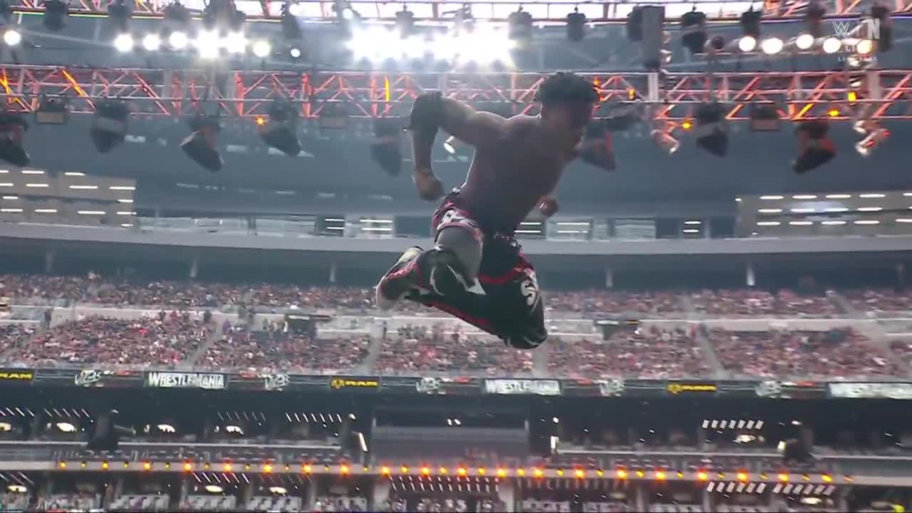 Slow-motion angle of IShowSpeed jumping through the table on Logan Paul at WrestleMania