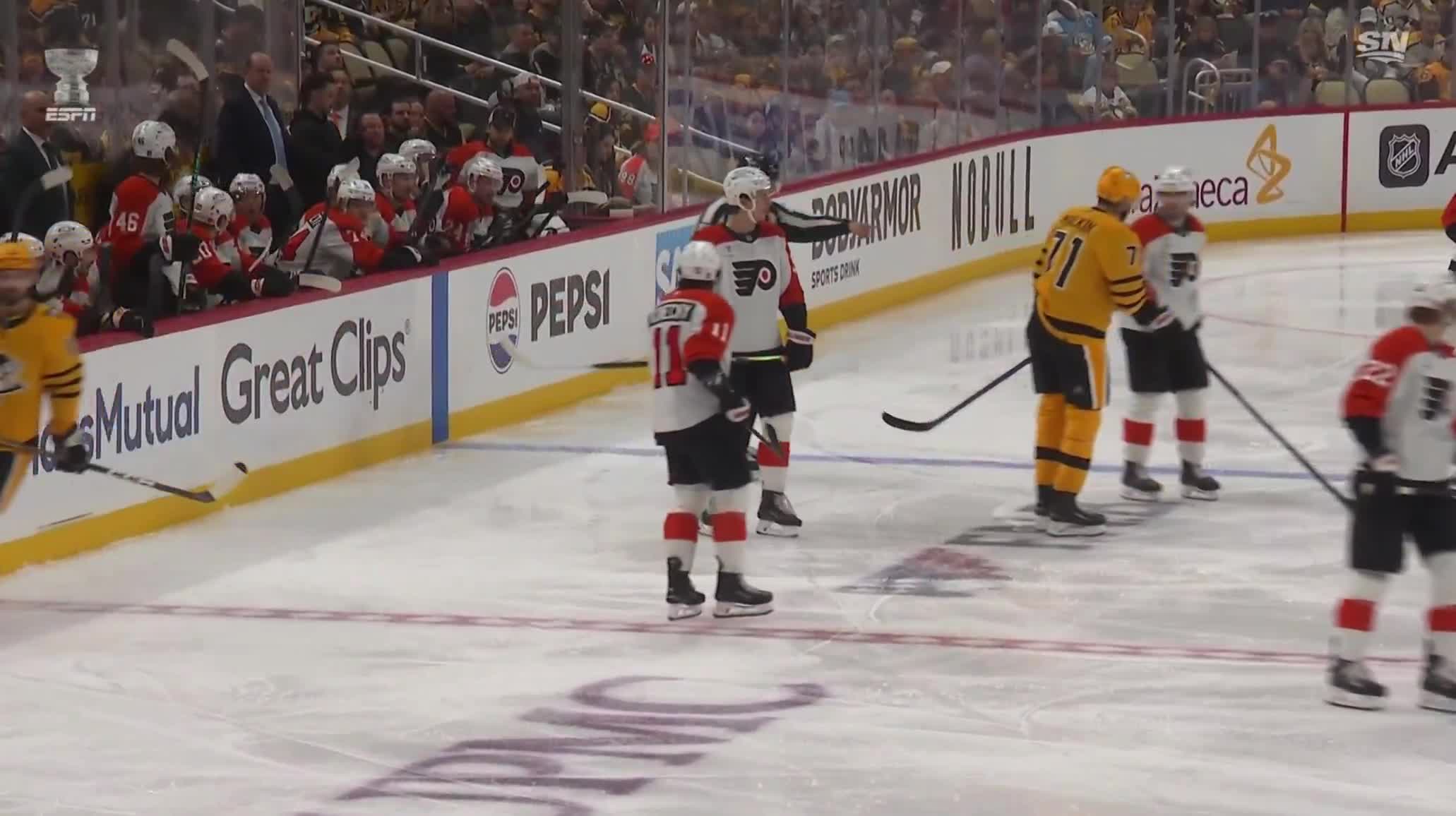 Evgeni Malkin backhanded the puck into the Flyers' bench during a stoppage in play