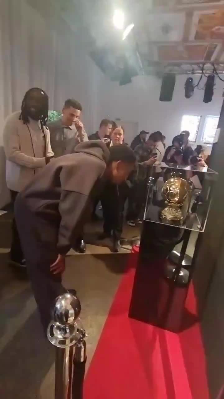 Myles Lewis-Skelly taking in the Ballon d’Or trophy at last night’s Topps FC event