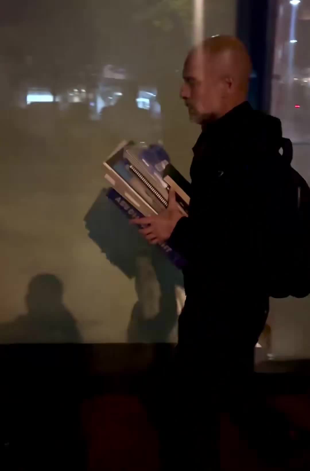 Pep Guardiola carries all his books after the match