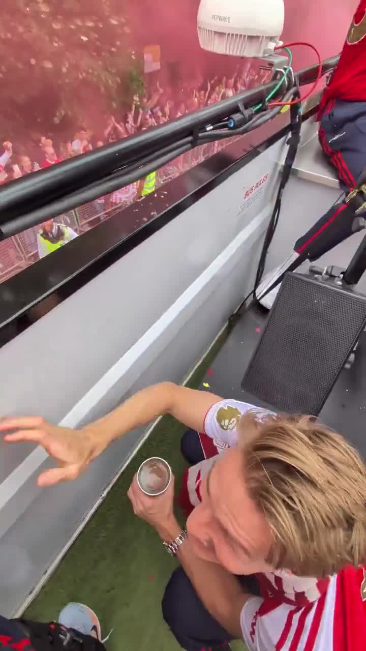 Martin Ødegaard heads a ball into a police officer during Arsenal's title parade.