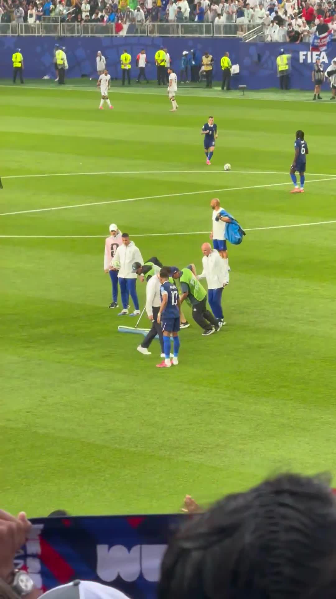 Kylian Mbappé showing the staff where the pitch is flooded