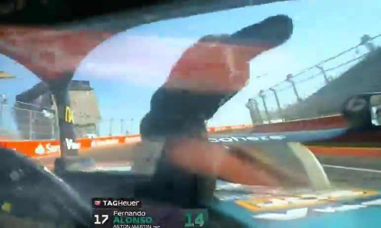 Fernando Alonso makes a hand gesture during the lap