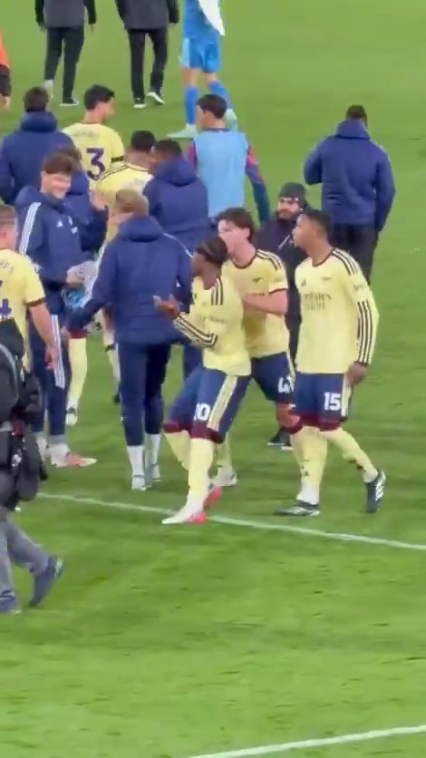 Declan Rice and Martin Ødegaard push Noni Madueke towards the fans to celebrate the win
