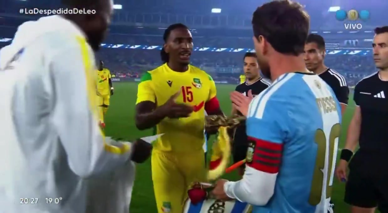Benin’s captain giving Messi a gift