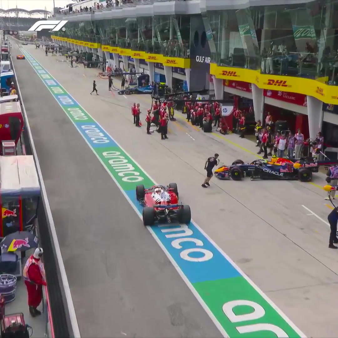 Charles and Isack nearly tangle in the pit lane